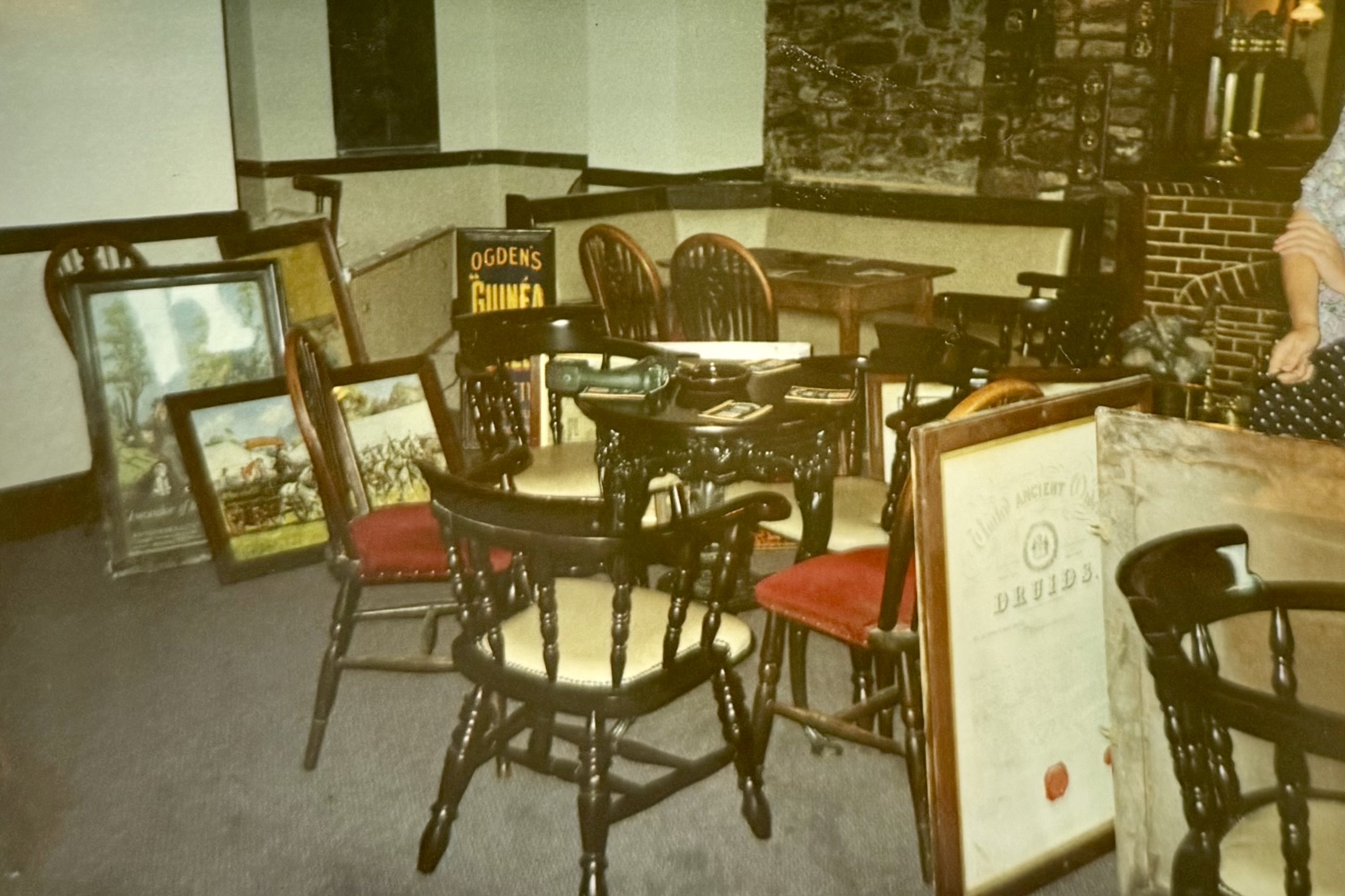 Some frames gathered in the Bar area, near the Snug, with some tables and chairs. Two of the frames (The Hancocks Brewery painting and the Druids frame) can still be found in the Bar today.