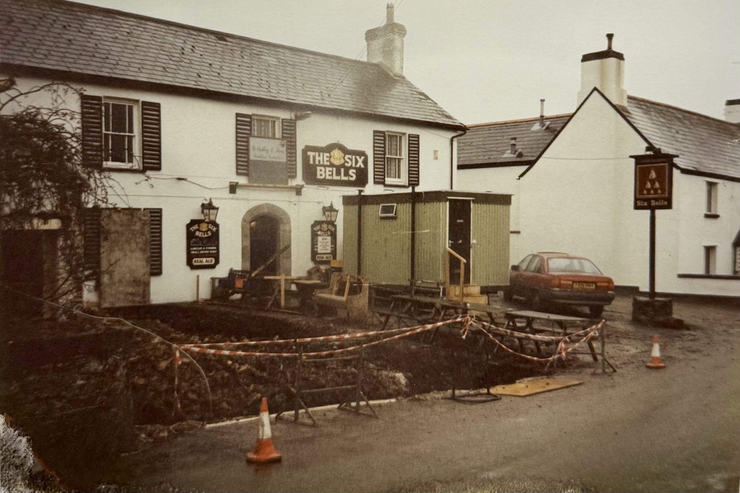 The pub from the front - the foundations are being dug out for the restaurant. A blocked up window can be seen, which was lost to the renovations.