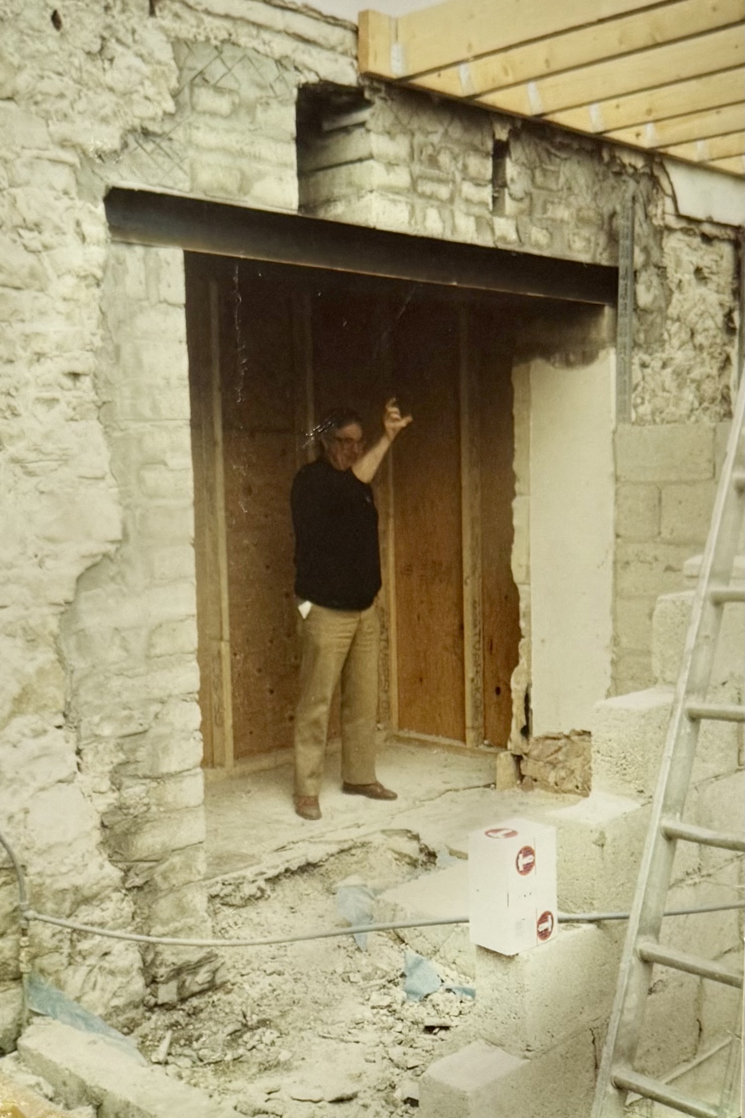 A man stood in part of the pub which is being extended.