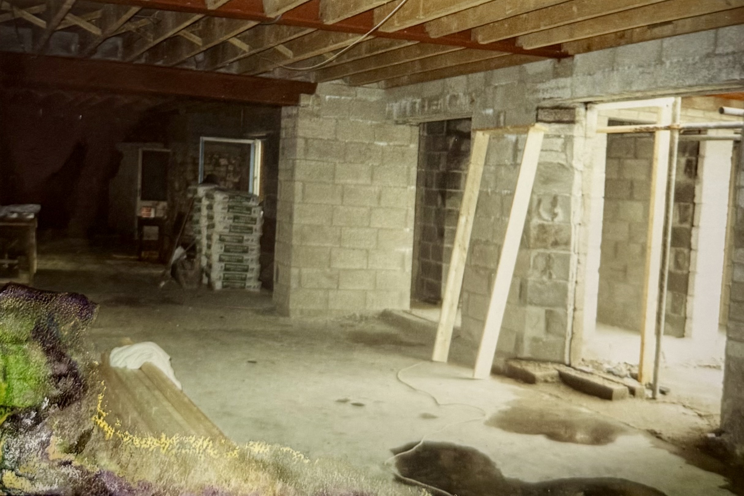 An area constructed from breeze blocks, with windows/doors being fitted.