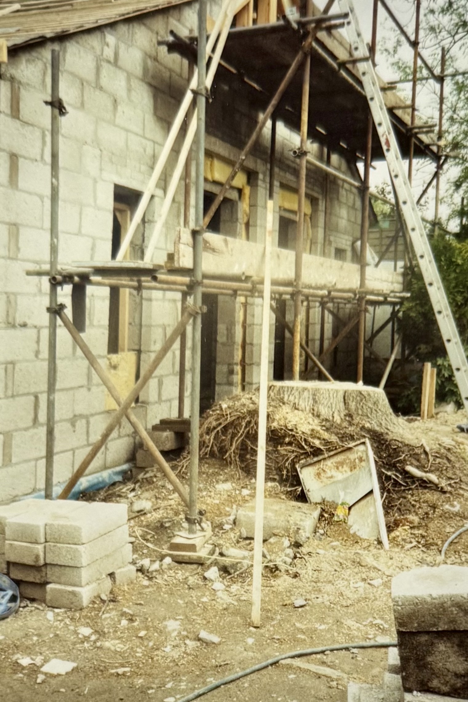 A large tree stump which was once directly outside the Function Room doors, which are still under construction. Scaffolding stands around the stump. Planning permission was applied and granted to remove this stump, along with a couple of other trees in the car park.