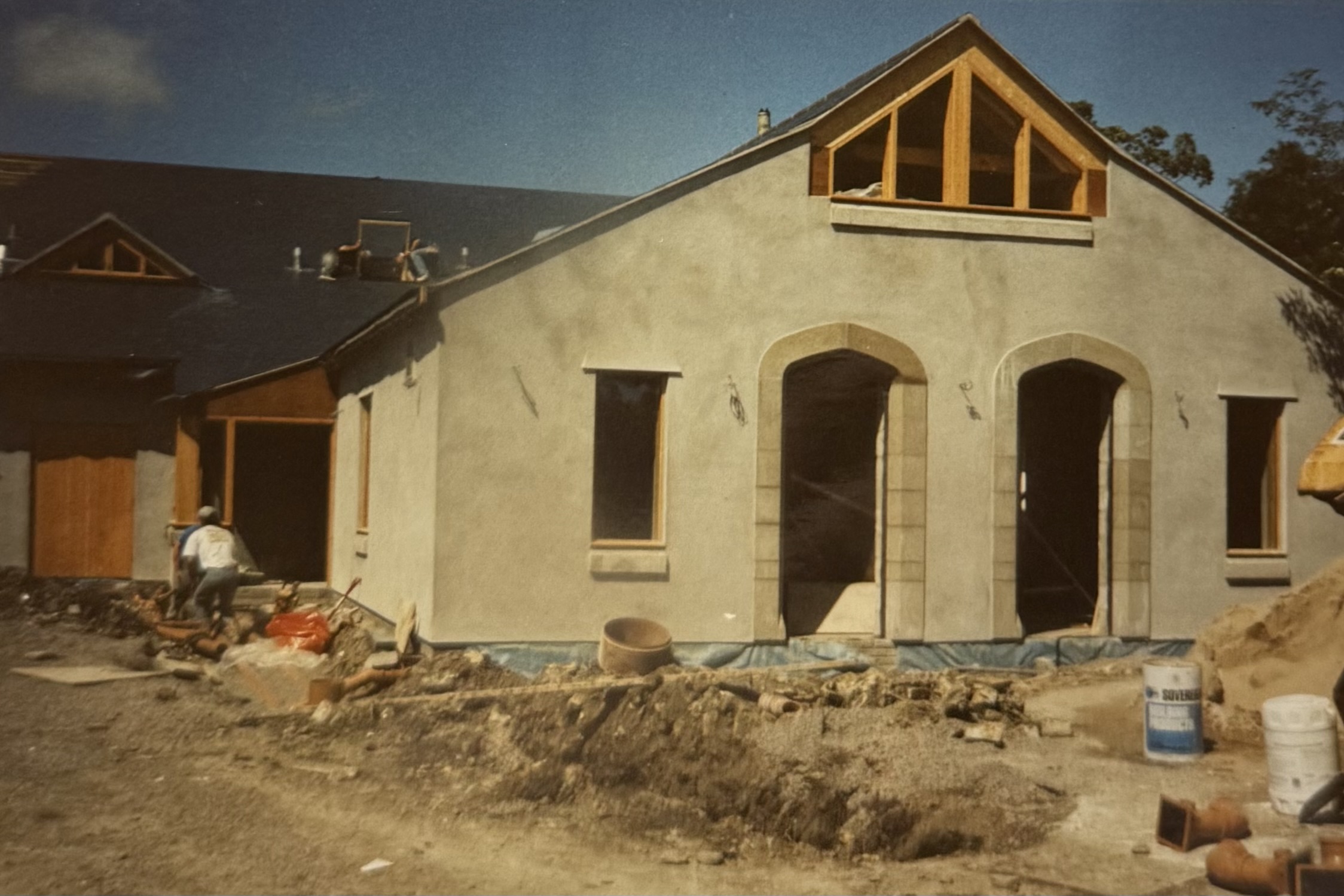 Taking shape at the back - the walls of the Function Room have been rendered, and the cellar doors have been fitted. Two men are fitting a window which sits above the stairs leading to the accomodation above the pub.
