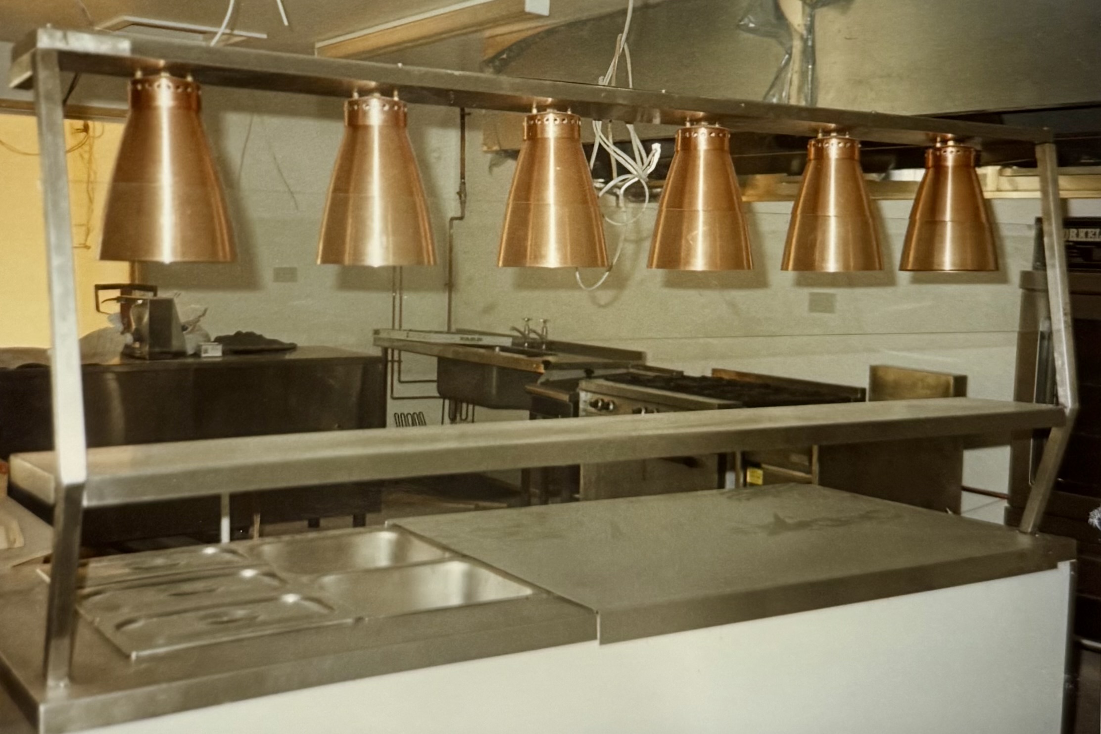 Some heat lamps on a counter in the newly constructed kitchen.