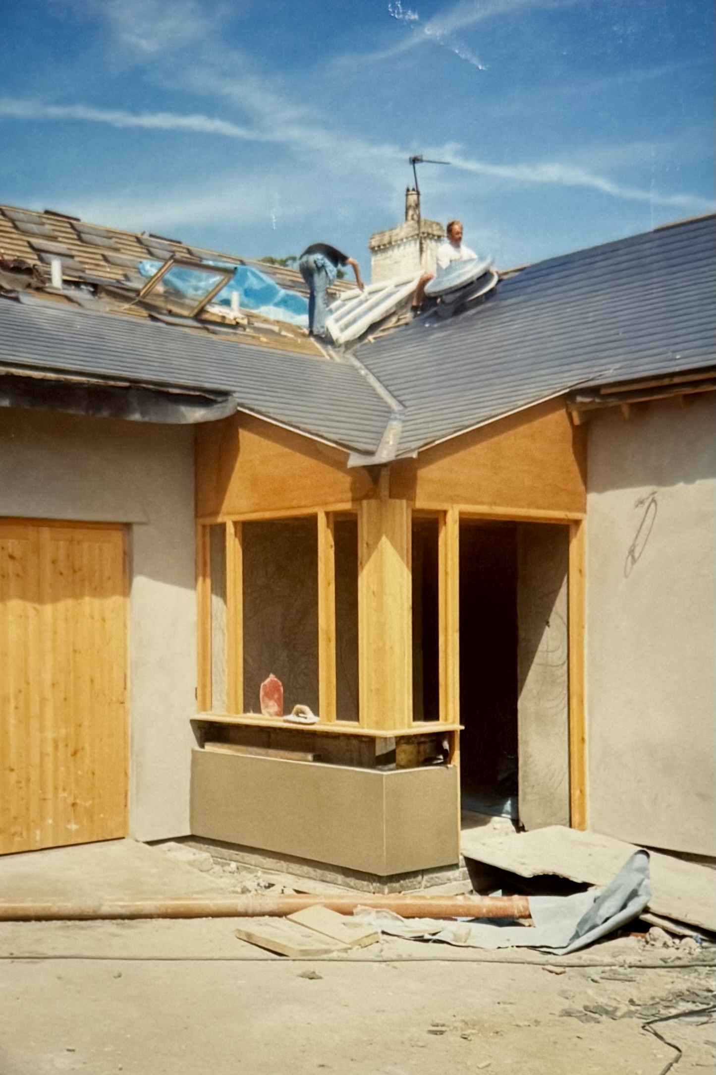 Some workmen on the roof above the back porch/upstairs accommodation.