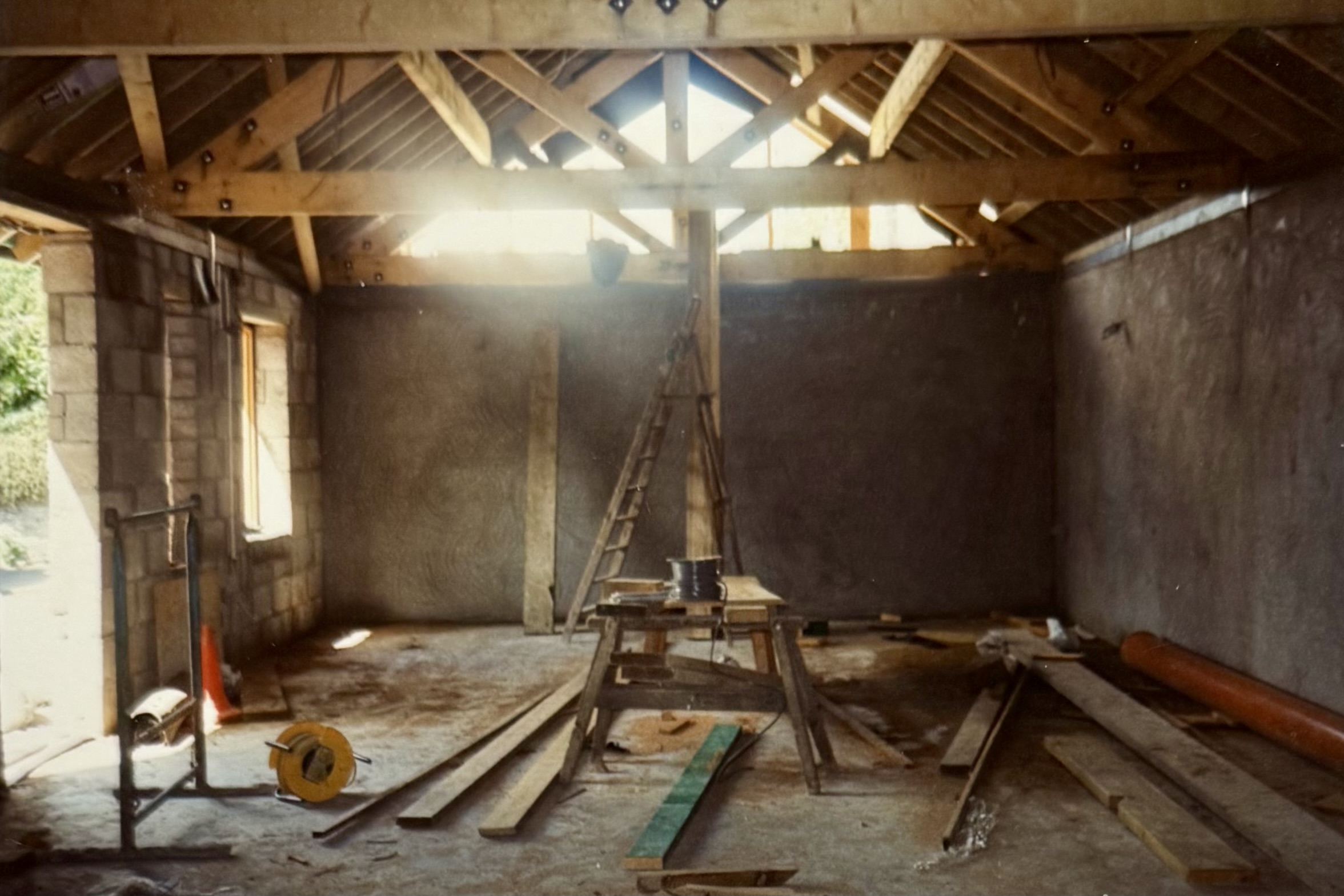 The back of the Restaurant, mid-renovation. There's building materials and a ladder, and the ceiling is being propped up.