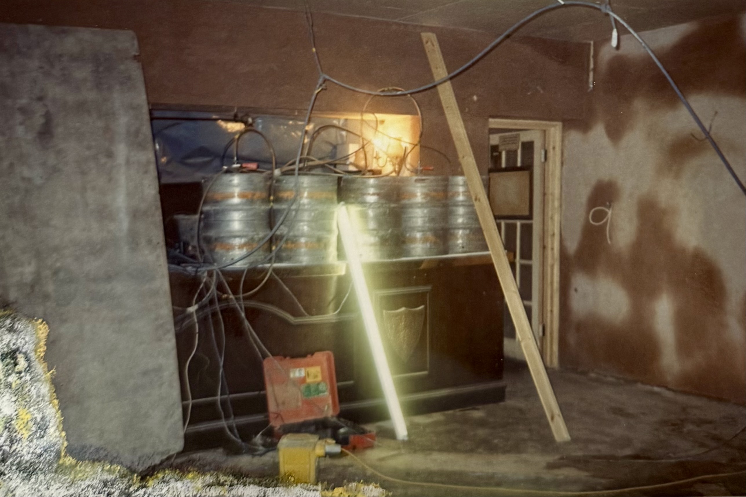 Numerous barrels on the lounge side bar, mid-renovation. There's building materials and wiring everywhere, and the walls have been freshly plastered.