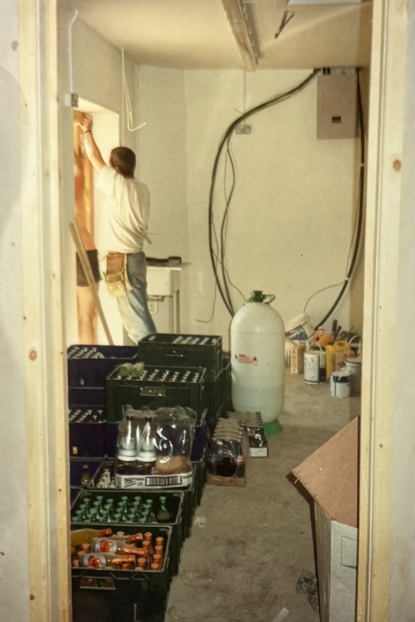 From the inside cellar door, showing a man fitting the outside doors to the cellar.