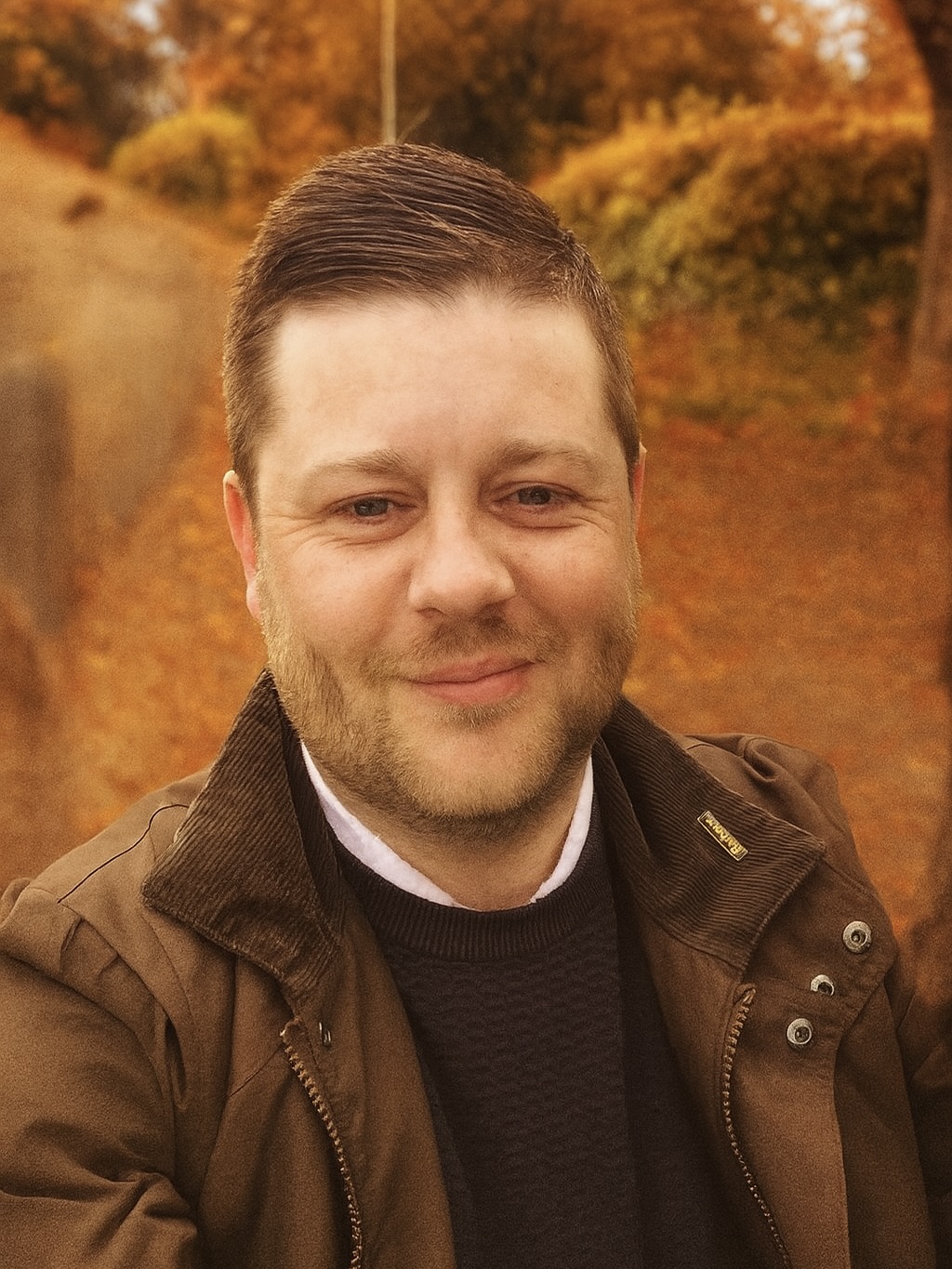 Kyle stood in a grassy field, admiring the view.